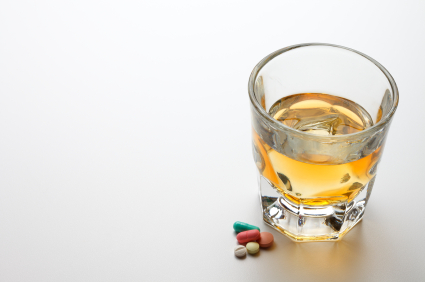 image of pills and a glass of whiskey